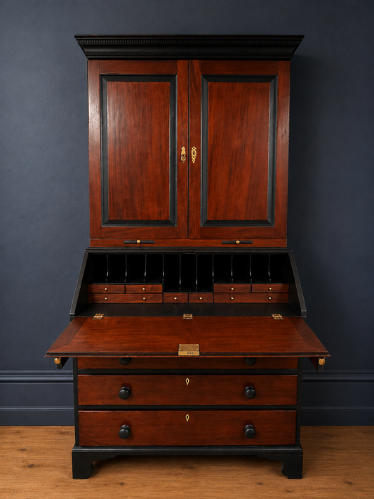 Wooden secretary desk with two cabinets against a dark blue wall.